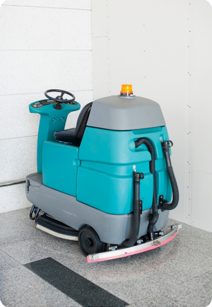 ride on scrubber sitting against a wall